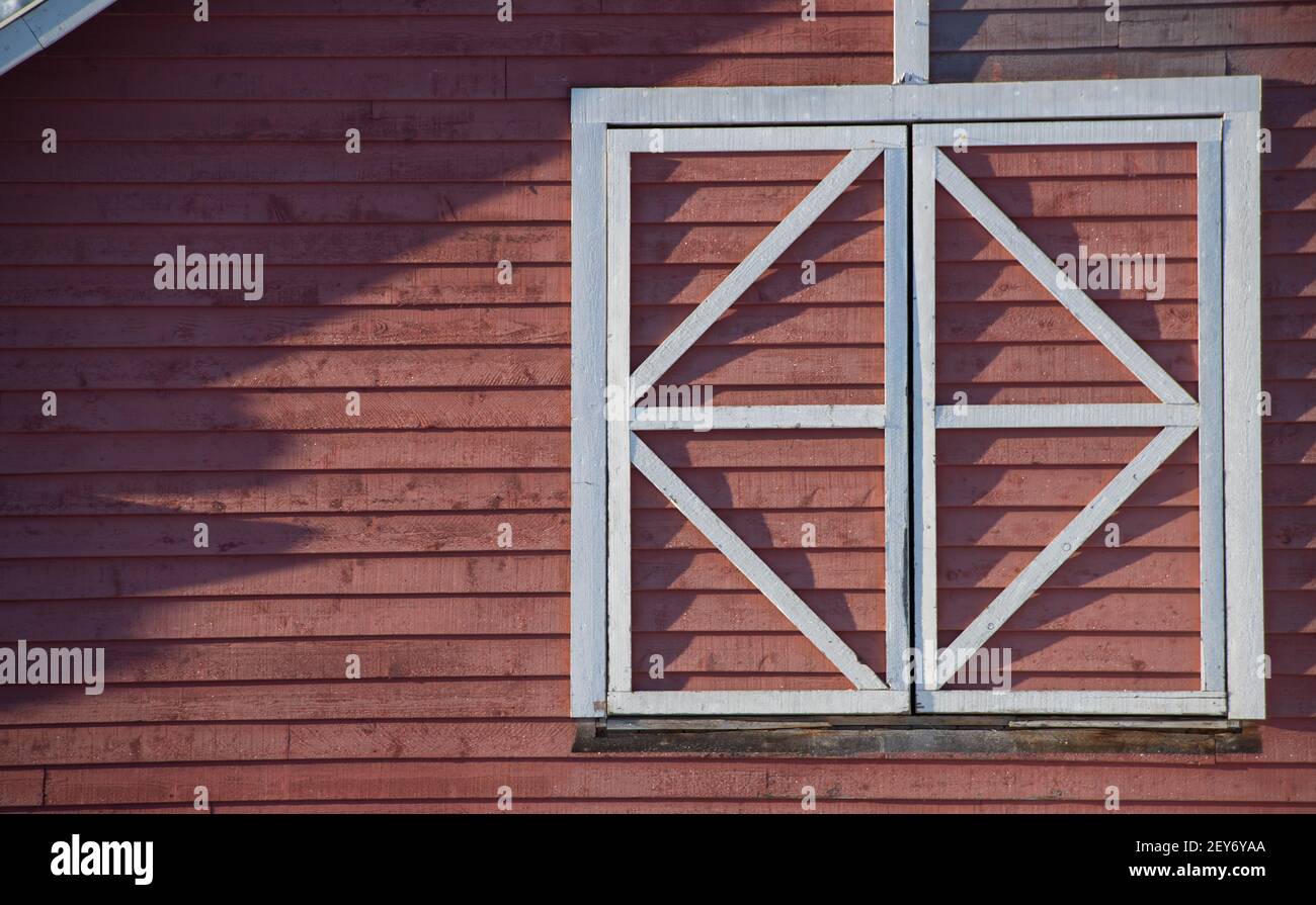 white square geometrical shaped wooden window frame on old red wooden ...