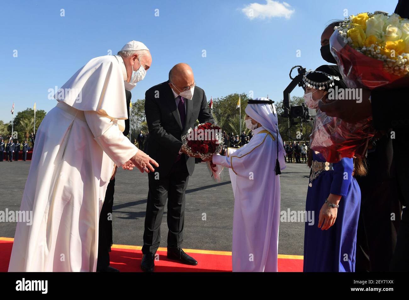 Baghdad, Iraq. 05th Mar, 2021. An Iraqi child offers Pope Francis a bouquet of flowers upon his arrival at at Baghdad Airport in Iraq on Friday, on March 5, 2021. Photo by Office of the Iraqi President/UPI Credit: UPI/Alamy Live News Stock Photo