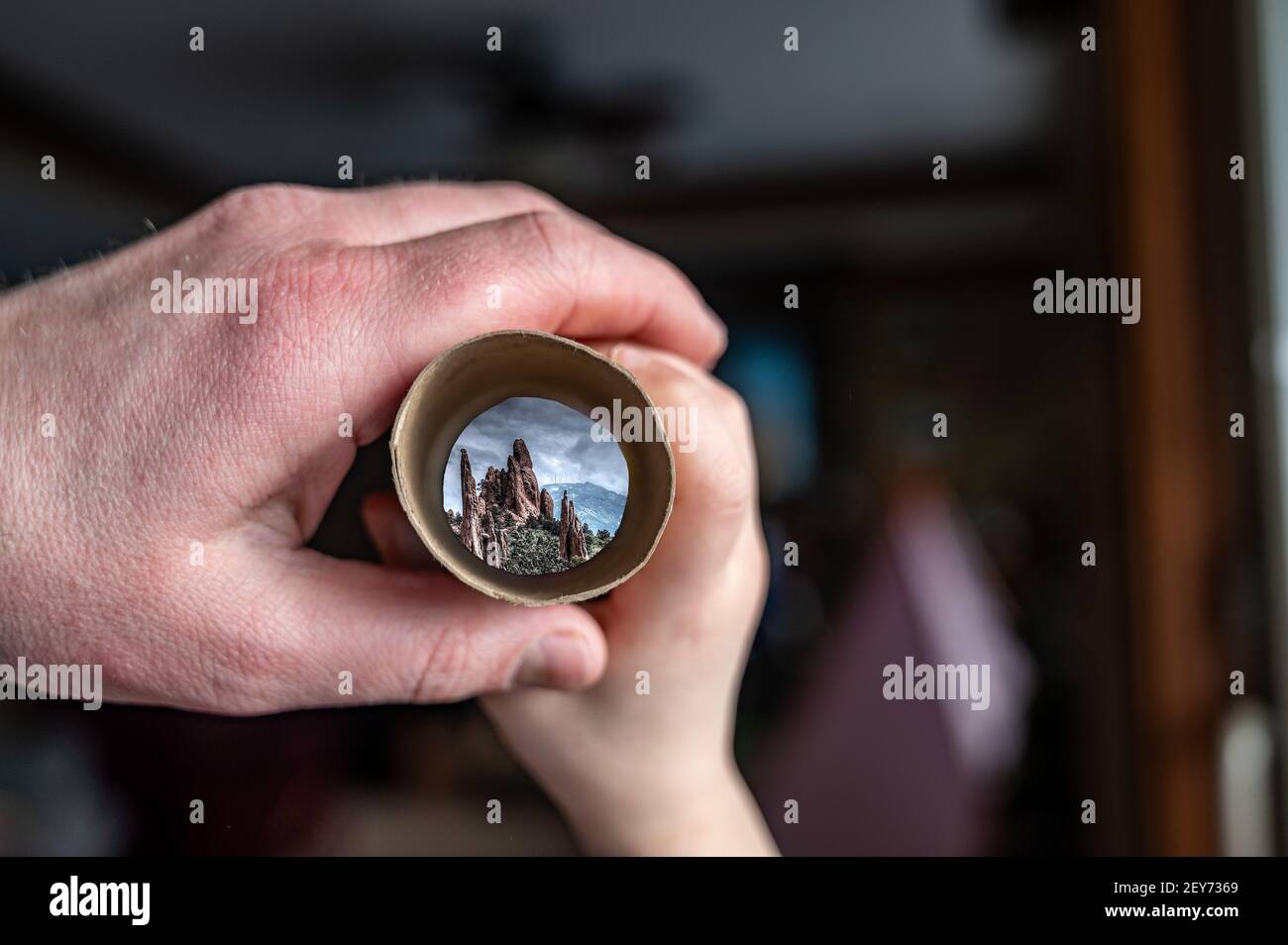 Father and Child using imagingation to play with a cardboard tube as a