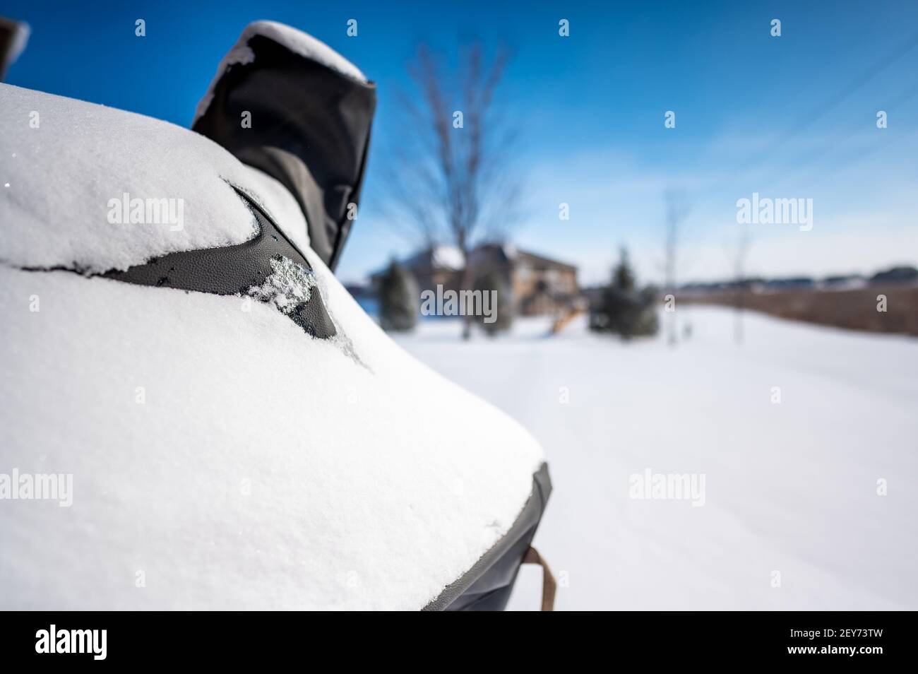 Snow covered BBQ smoker grill in the backyard with winter background