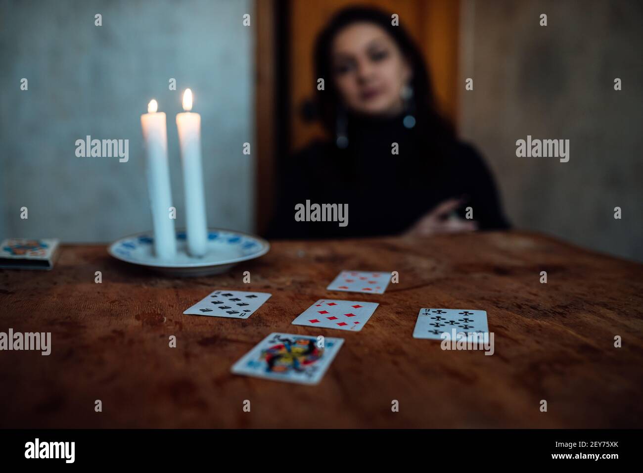 choose a card from the hands of a fortune teller. a woman tells fortunes during a magical ritual. belief in mysticism Stock Photo