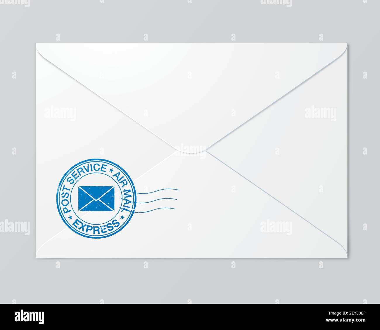 White mail envelope with a blue postal service stamp lying on the grey