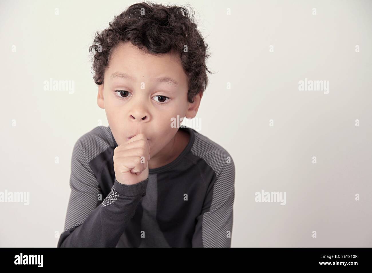 boy sucking thumb on white background stock photo Stock Photo