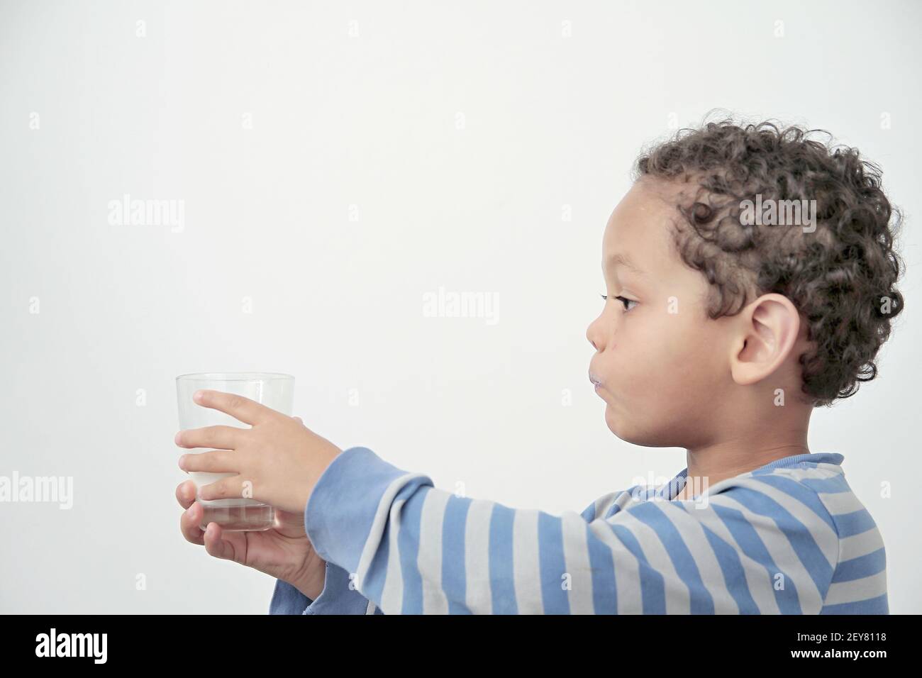 child drinking milk for breakfast on white background stock photo Stock Photo