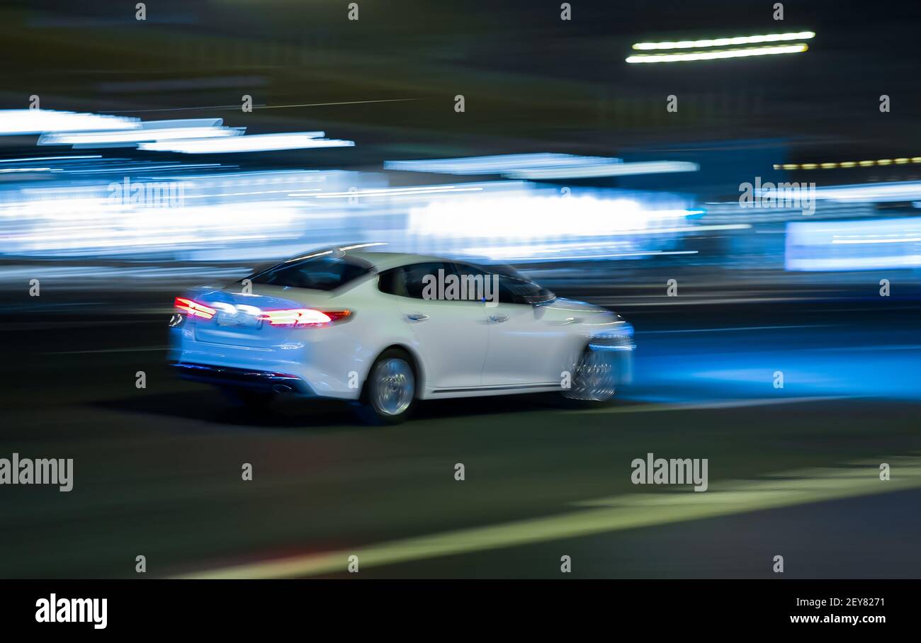 modern cars go on the night city. blurred motion Stock Photo - Alamy