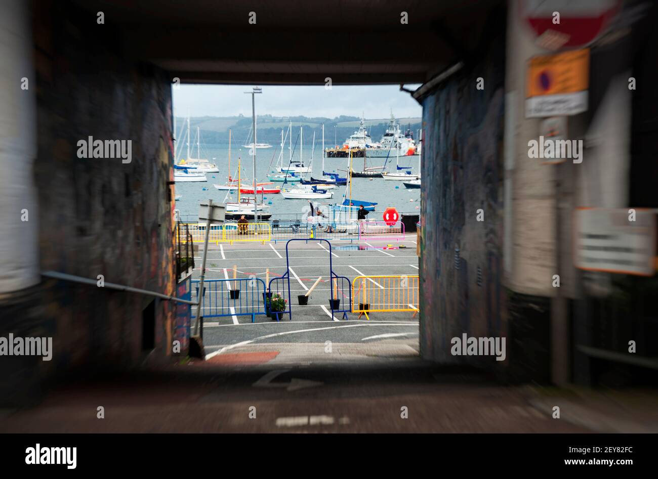 Skateboarders practice their tricks against a backdrop of Falmouth harbour, Cornwall, UK Stock Photo