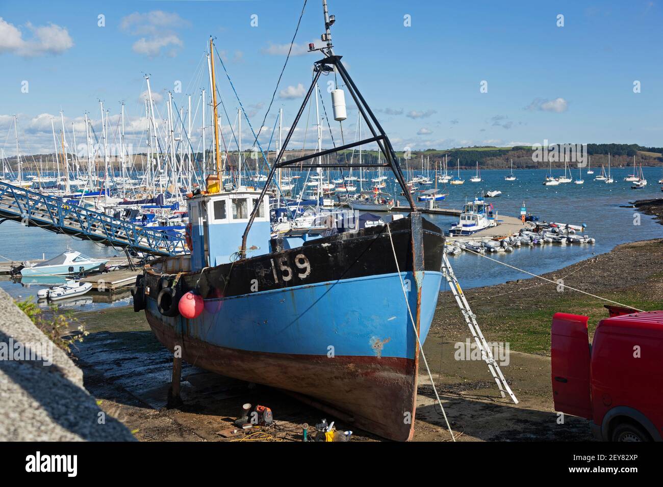 A trawler being maintained on a slipway at low tide, Mylor Yatch Harbour near Penryn and Falmouth, Cornwall ,UK Stock Photo
