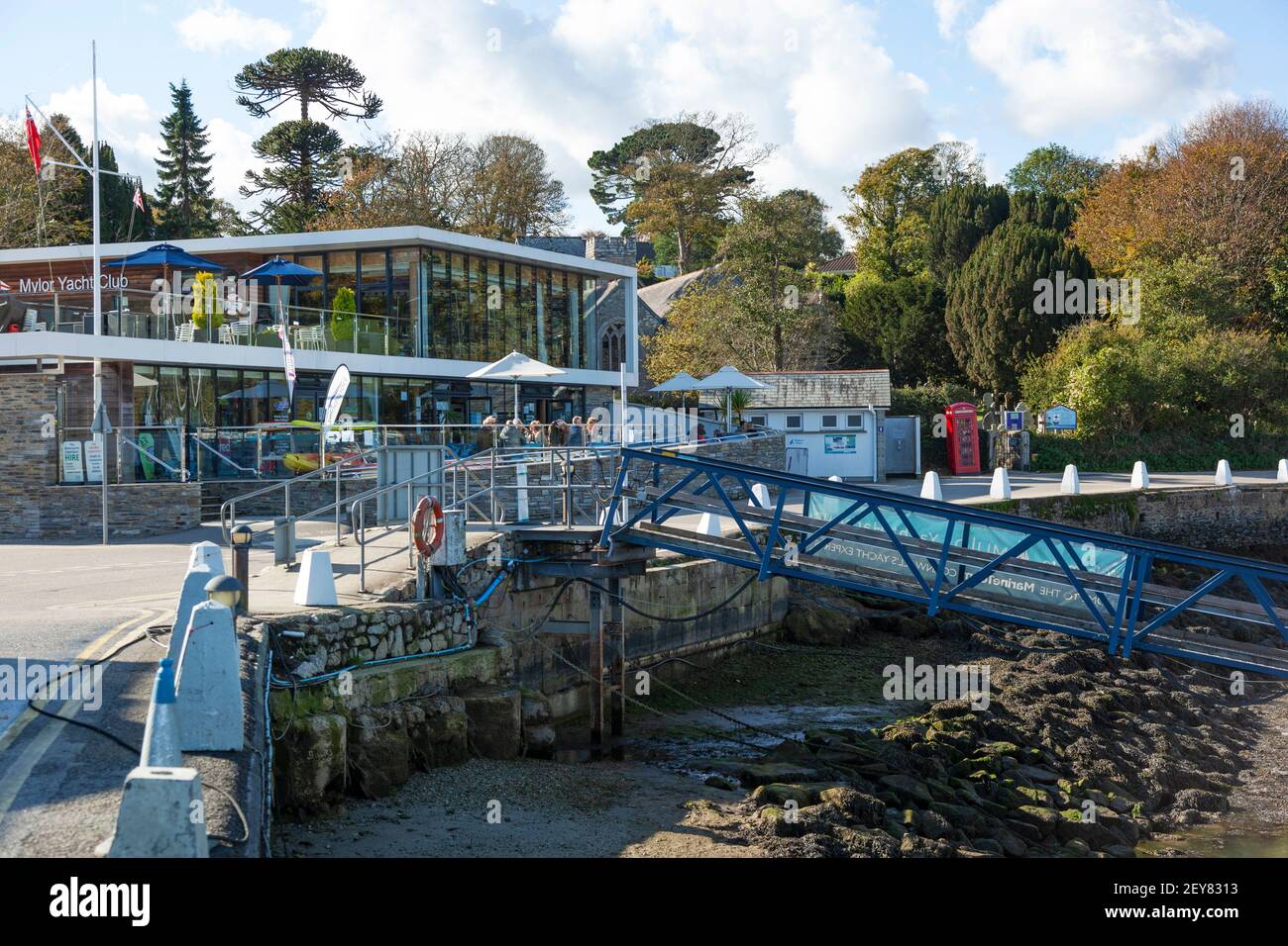 The Mylor Yacht Club with outdoor dining and views from the harbourside on Mylor Creek near Falmouth in Cornwall Stock Photo