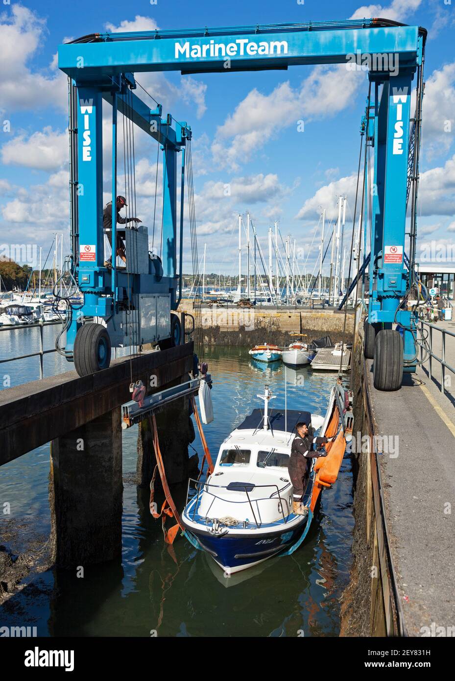 A boat is prepared for lifting out from the water at Mylor Yacht Harbour near Falmouth in Cornwall for maintenance and storage. Stock Photo