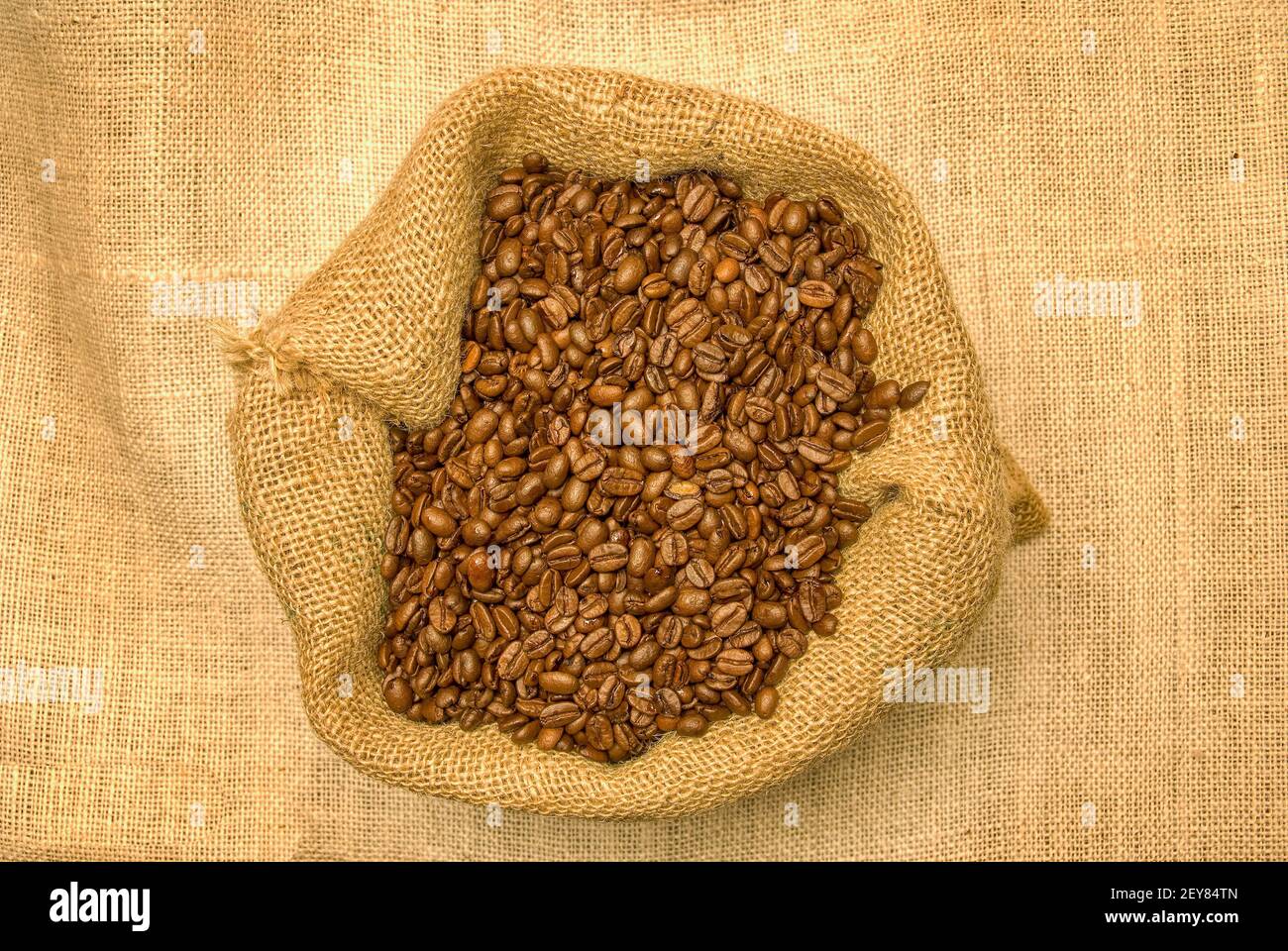 Horizontal shot looking down on an open bag of coffee beans. This is a