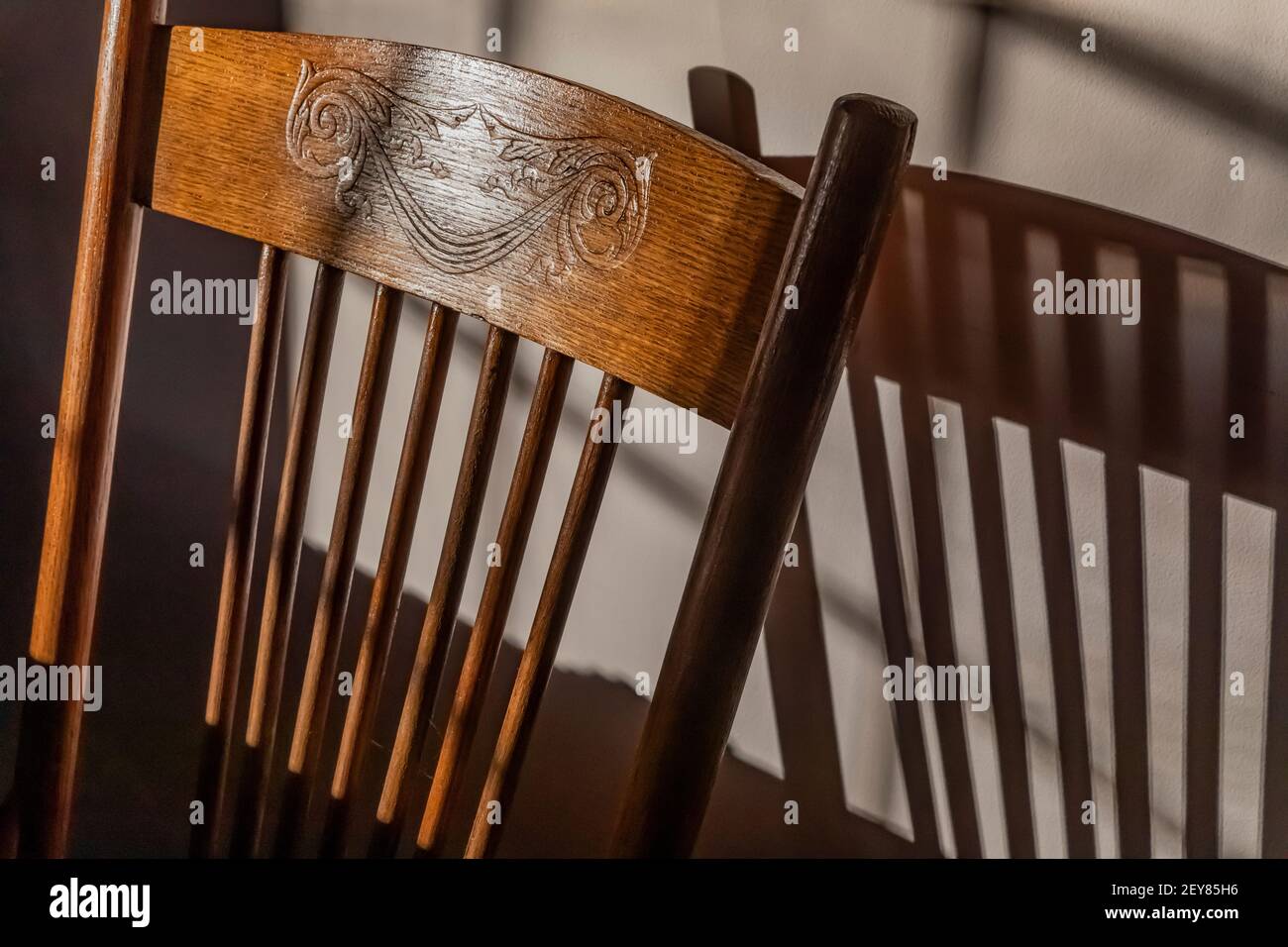 Shadows cast by an old oak chair in late afternoon sunlight in winter in central Michigan, USA Stock Photo