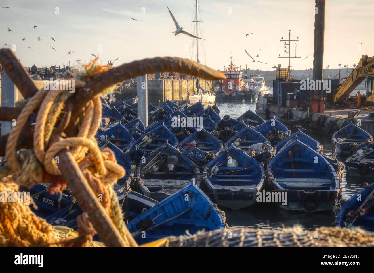 Romantic small fishing harbour with blue fishing boats Stock Photo