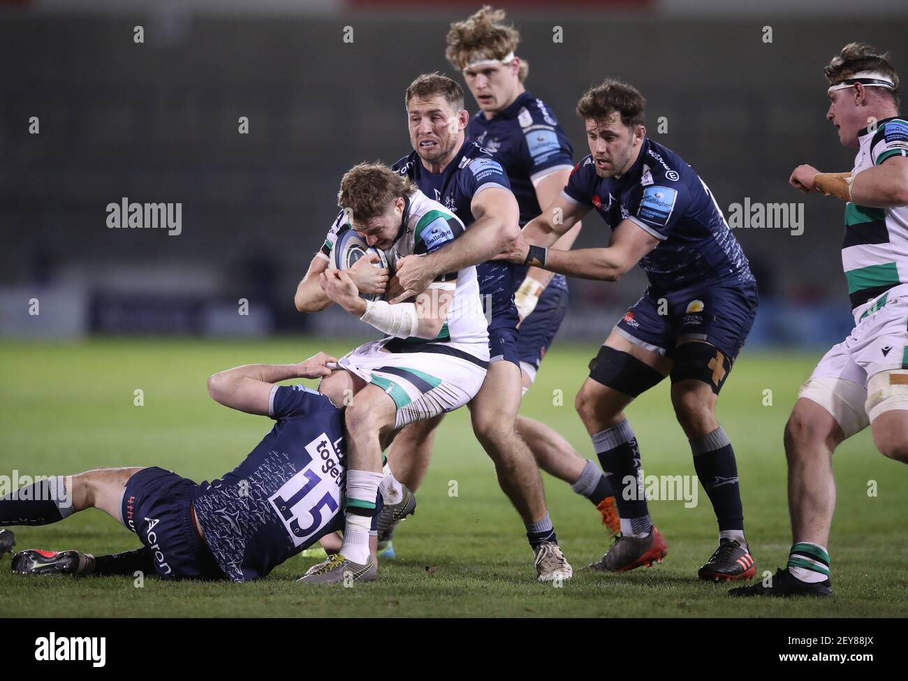 Newcastle Falcons' Tom Penny (2nd left) is tackled by Sale Sharks' Luke  James (left) and Sam Hill (centre) during the Gallagher Premiership match  at the AJ Bell Stadium, Sale. Picture date: Friday