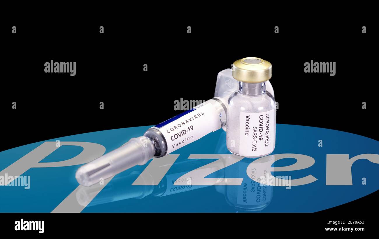 Silesia, Poland, March 2021: Pfizer coronavirus vaccine in ampoule and syringe on a black background. Vaccine for COVID-19 virus concept. Ampoule Stock Photo