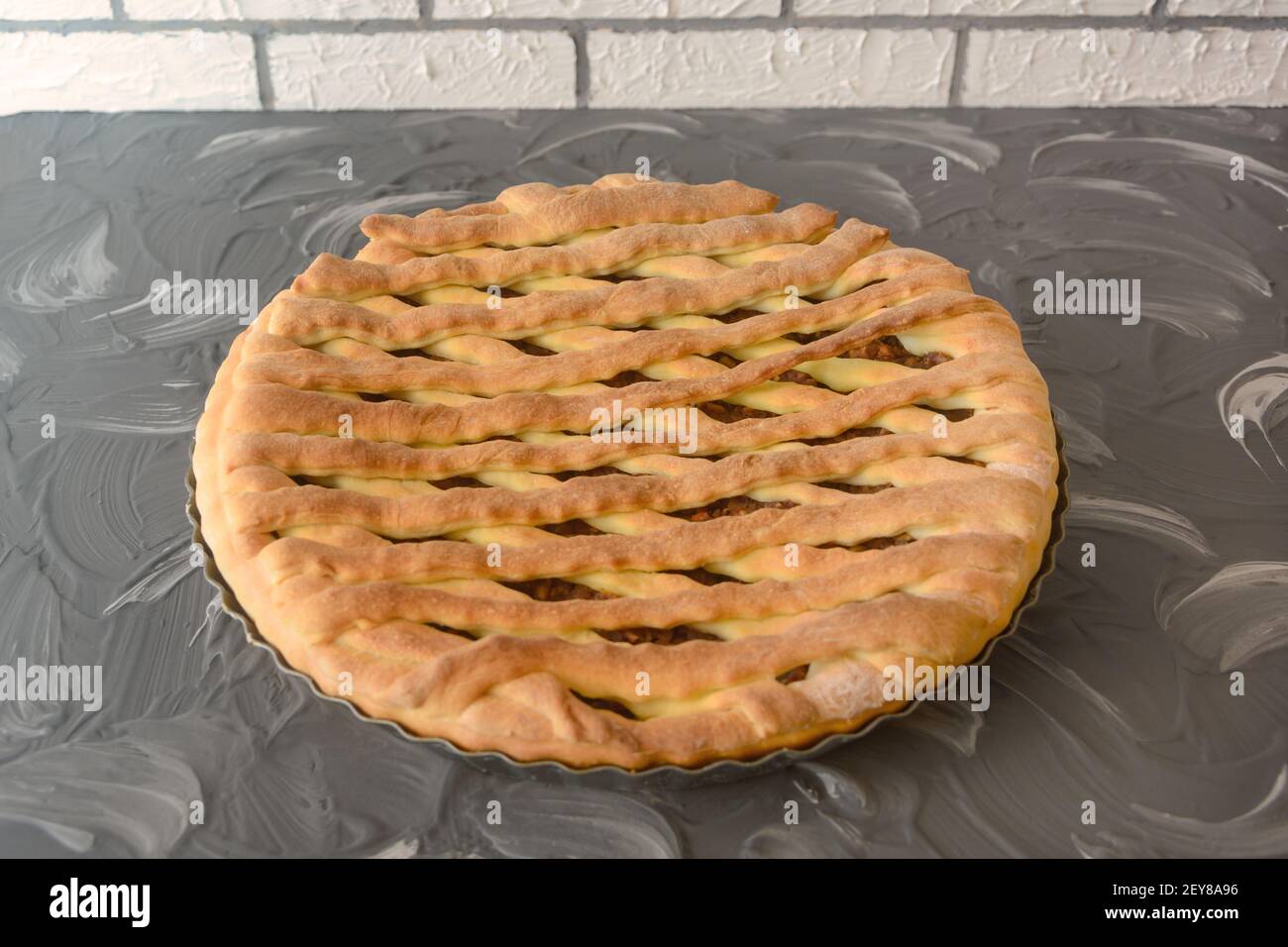 Homemade yeast dough pie. Pastries with sweet fruit filling. Close-up, selective focus. Stock Photo