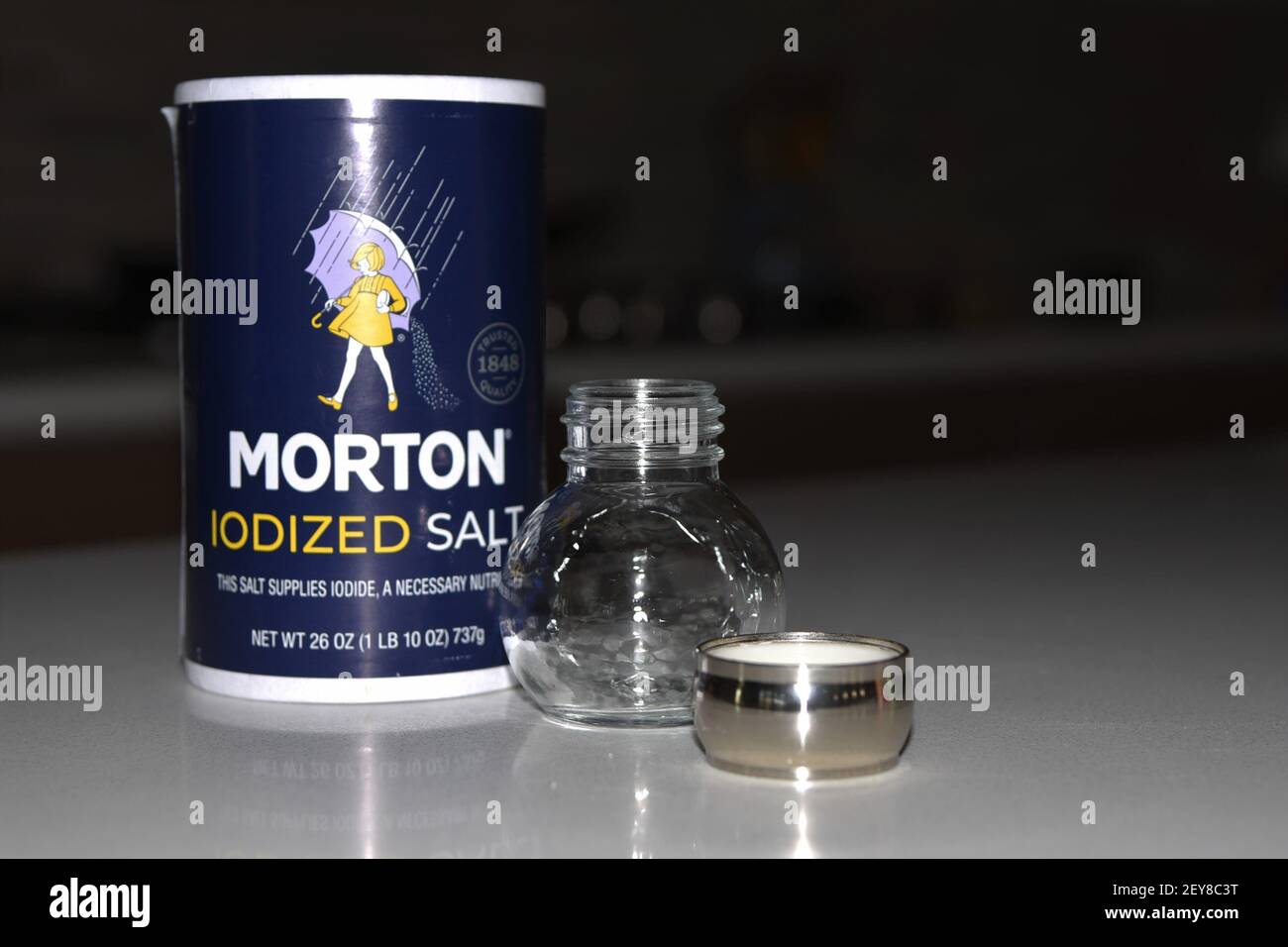 Box of Morton Iodized salt with empty salt shaker Stock Photo