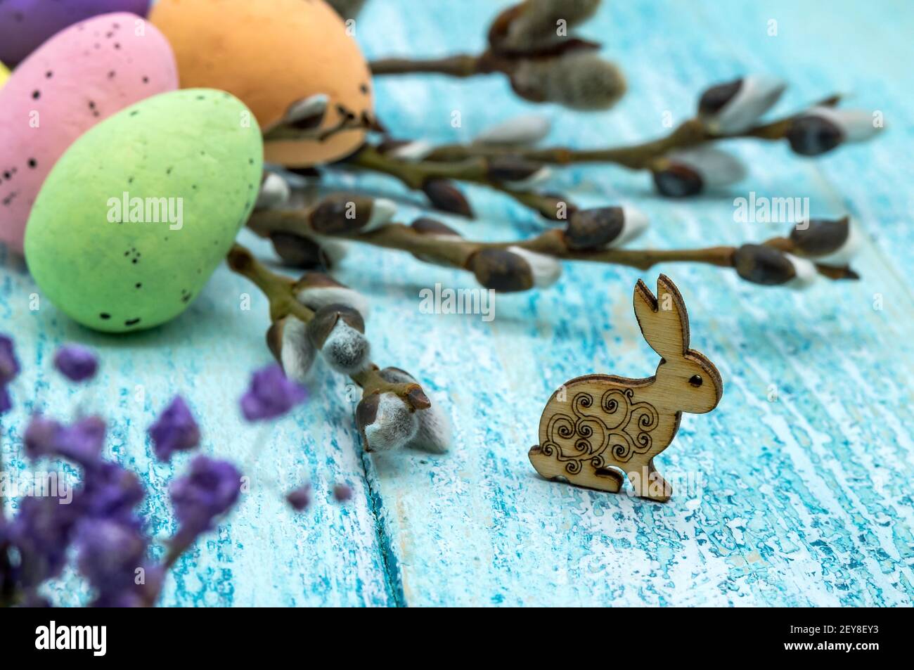 The Easter bunny. Happy Easter. Easter eggs. Willow twigs. Holy Easter. Blue background. Stock Photo