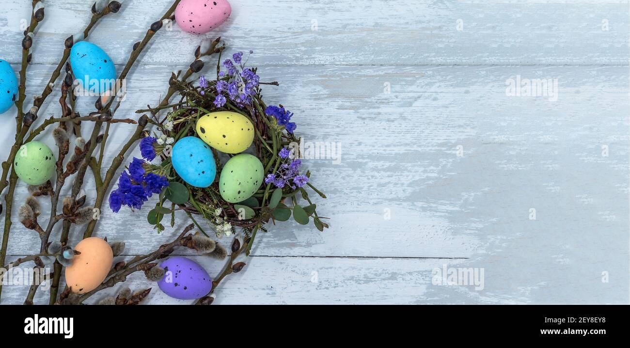 Happy Easter. Easter eggs. Willow twigs. Holy Easter. Easter eggs in the nest. Stock Photo