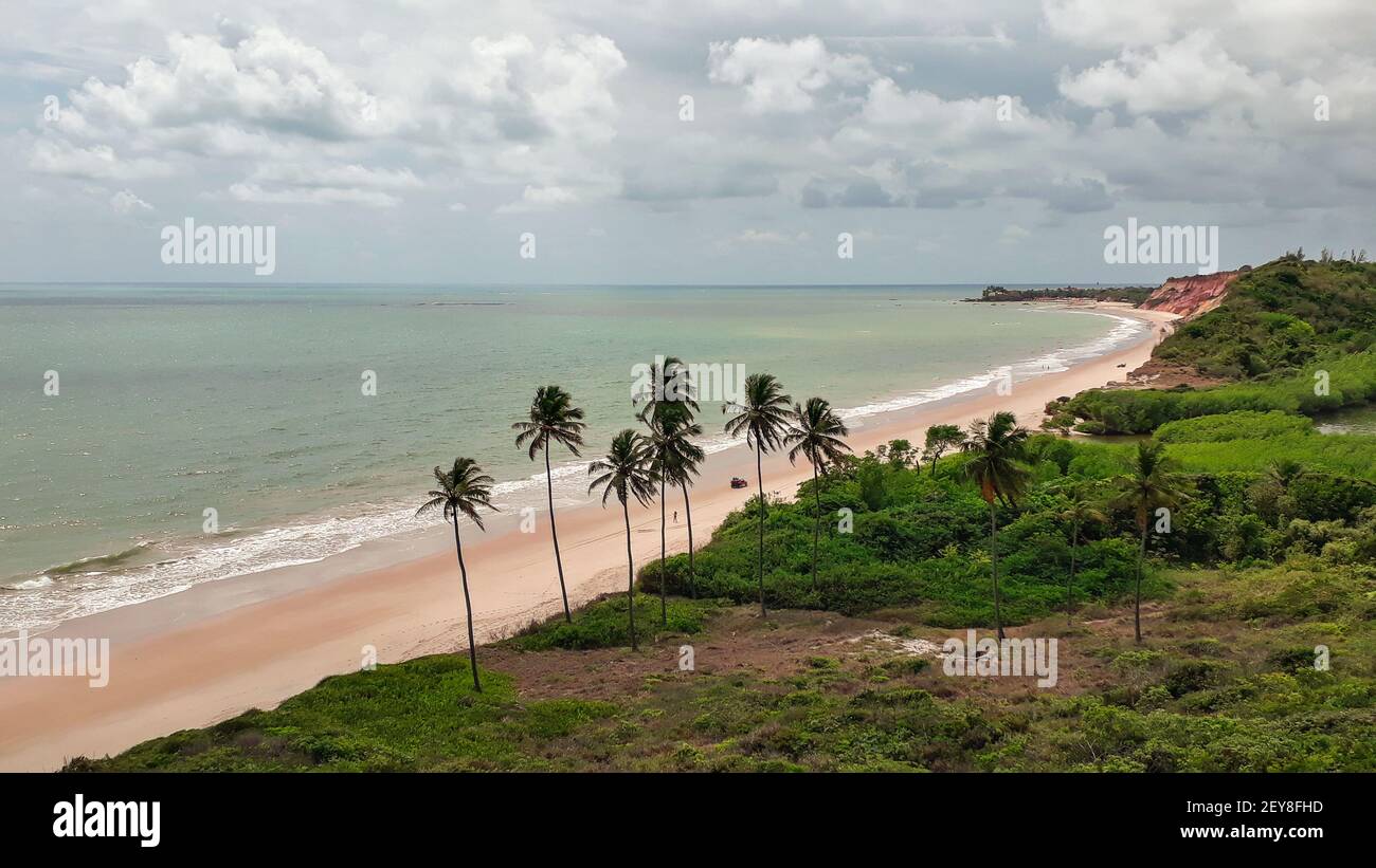 A beautiful view of the wavy ocean hitting the sandy beach under the ...