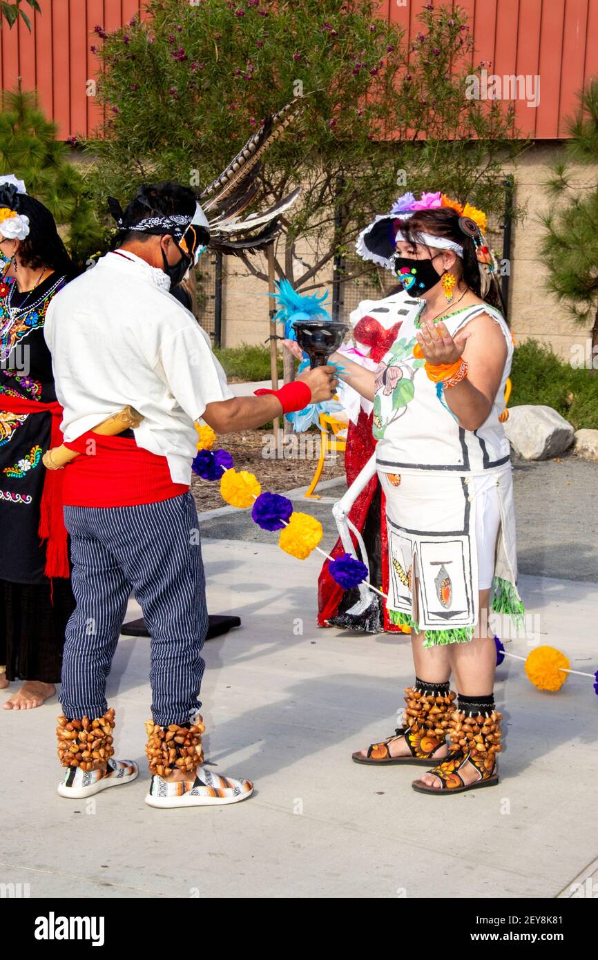 Costumed Hispanic celebrants participate in Day of the Dead ceremonies in Santa Ana, CA. Note face masks due to coronavirus pandemic.  The Day of the Stock Photo