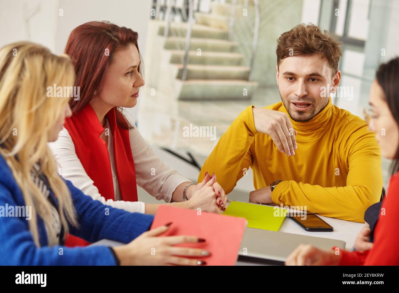 Image of business partners discussing documents and ideas at meeting Stock Photo