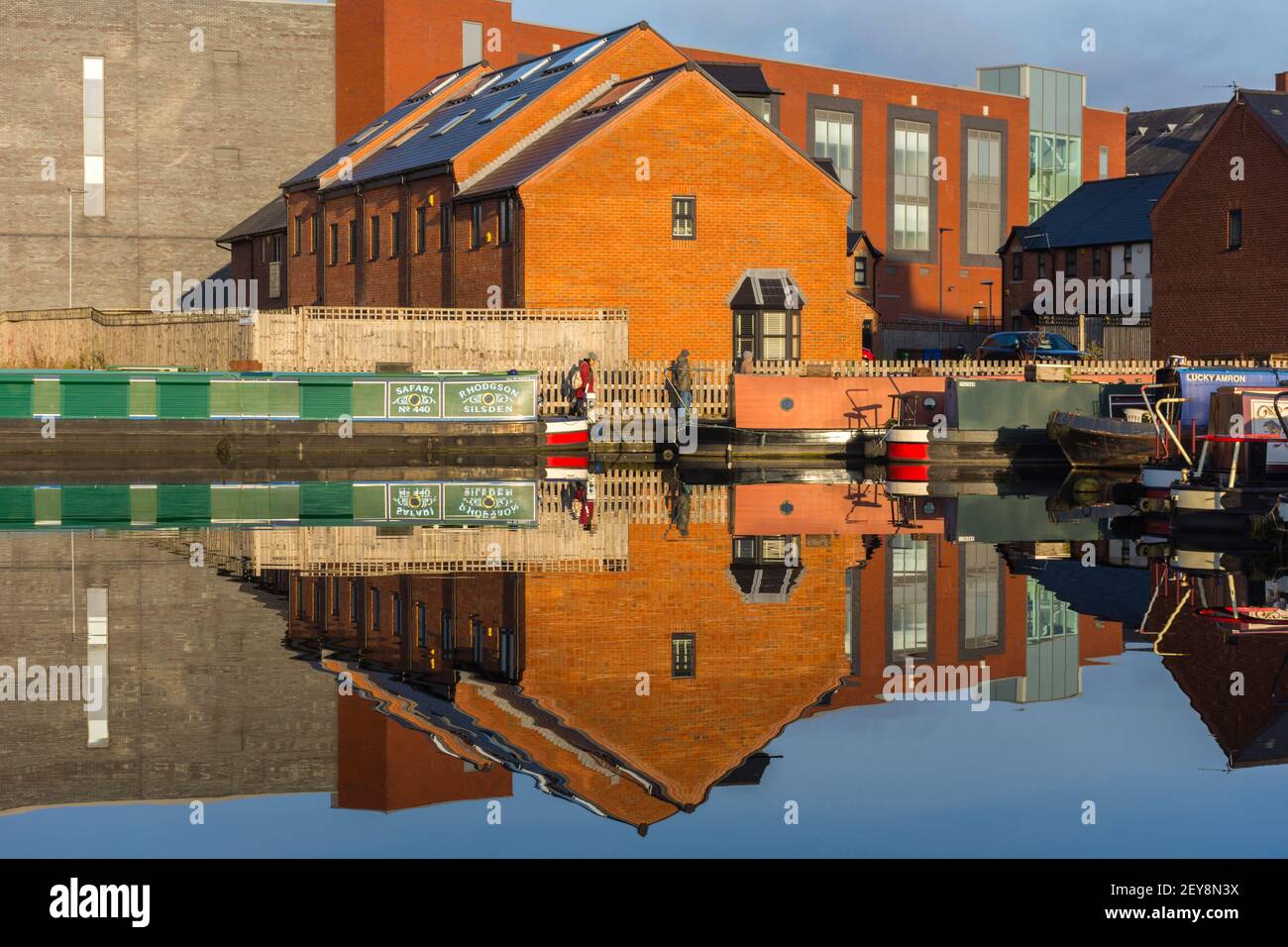 The Tony Downes House office block, and also houses, reflected in Droylsden Marina on the Ashton Canal, Droylsden, Tameside, Manchester, UK Stock Photo