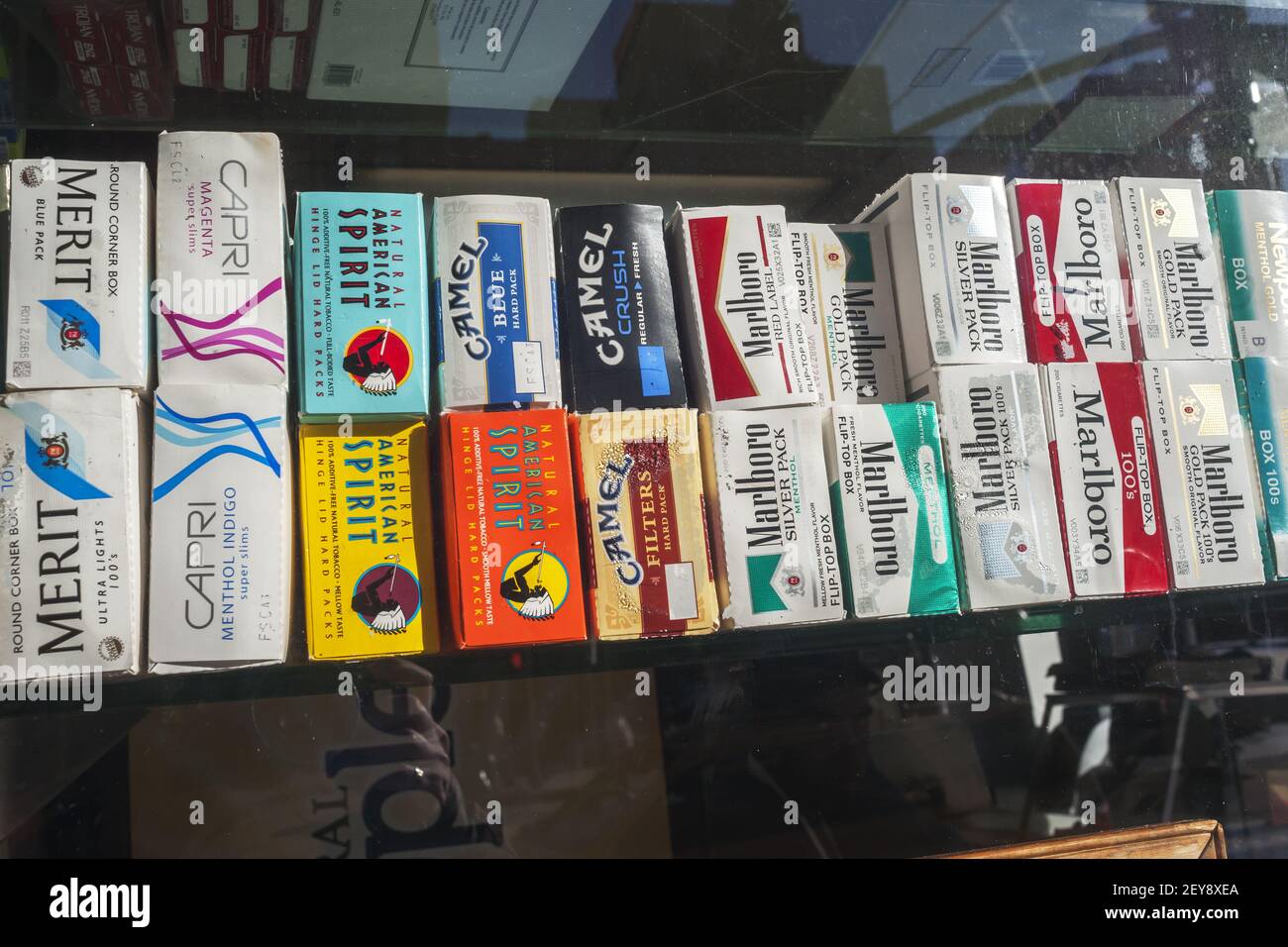 Cartons of cigarettes in the window of a grocery store in New York on