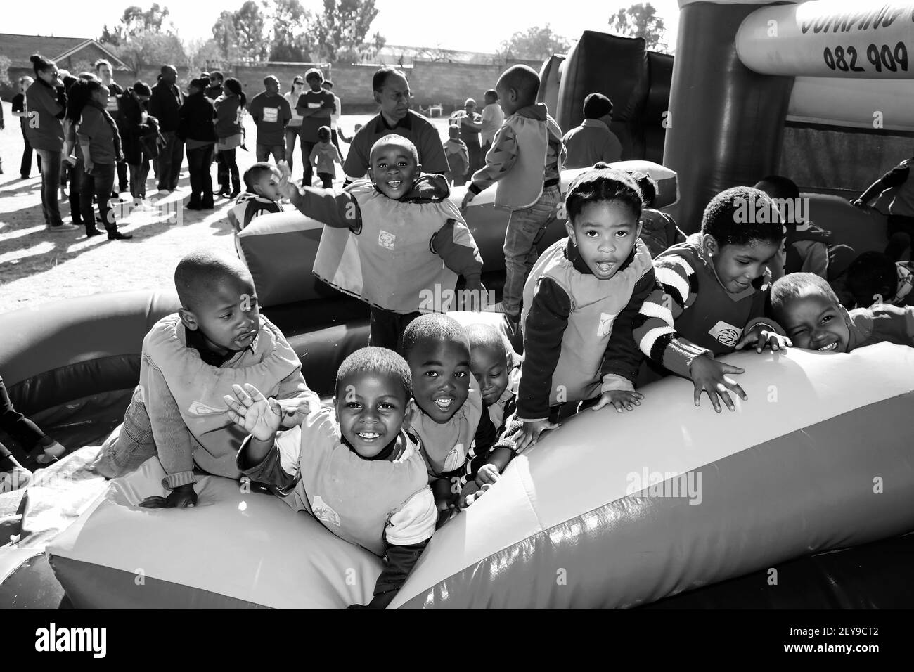 JOHANNESBURG, SOUTH AFRICA - Jan 05, 2021: Soweto, South Africa - July 18, 2012: Young African Preschool children having fun on a jumping castle on th Stock Photo