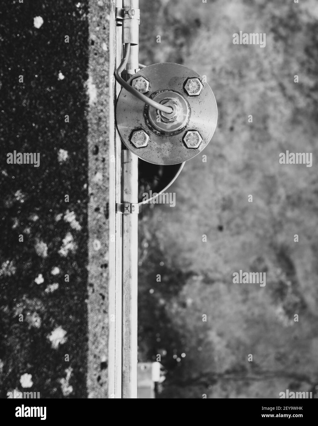 A vertical greyscale sho of metallic industrial equipment Stock Photo