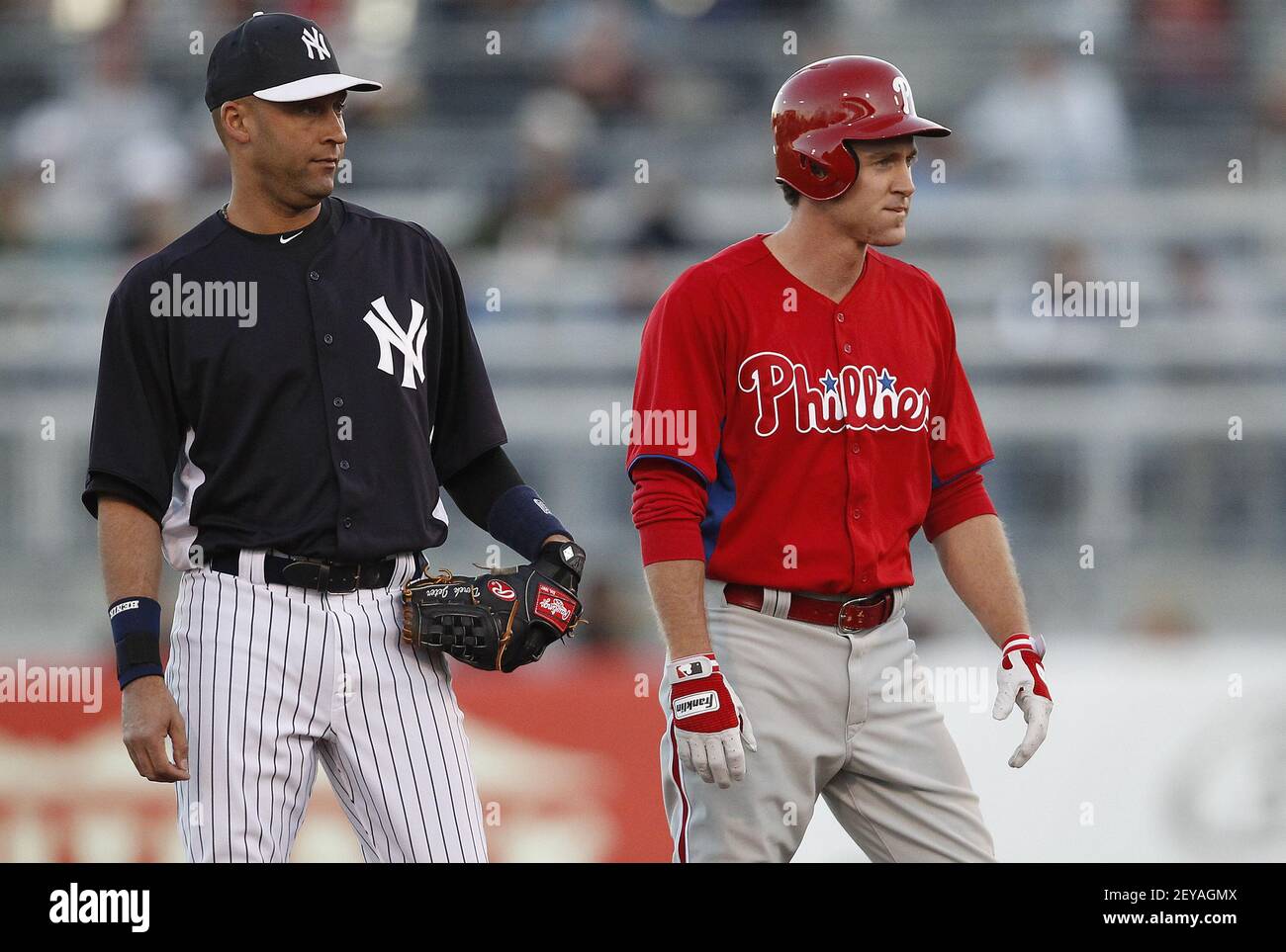 New York Yankees shortstop Derek Jeter, left, keeps an eye on the  Philadelphia Phillies' Chase Utley as he takes a lead from second base  during the first inning in Tampa, Florida, in