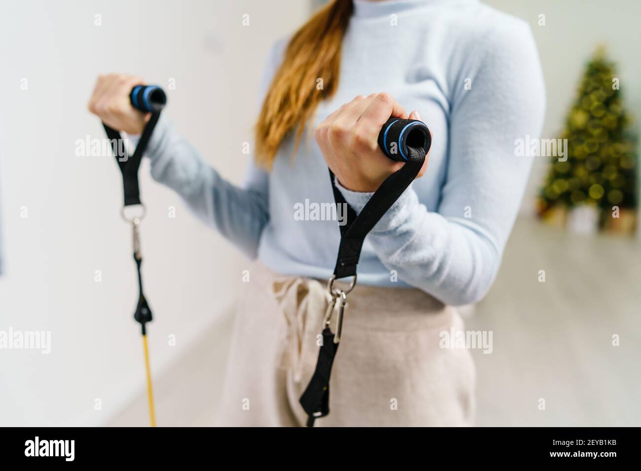 Close up on midsection of unknown caucasian woman holding rubber tubes resistance bands for training at home - copy space health and fitness concept Stock Photo