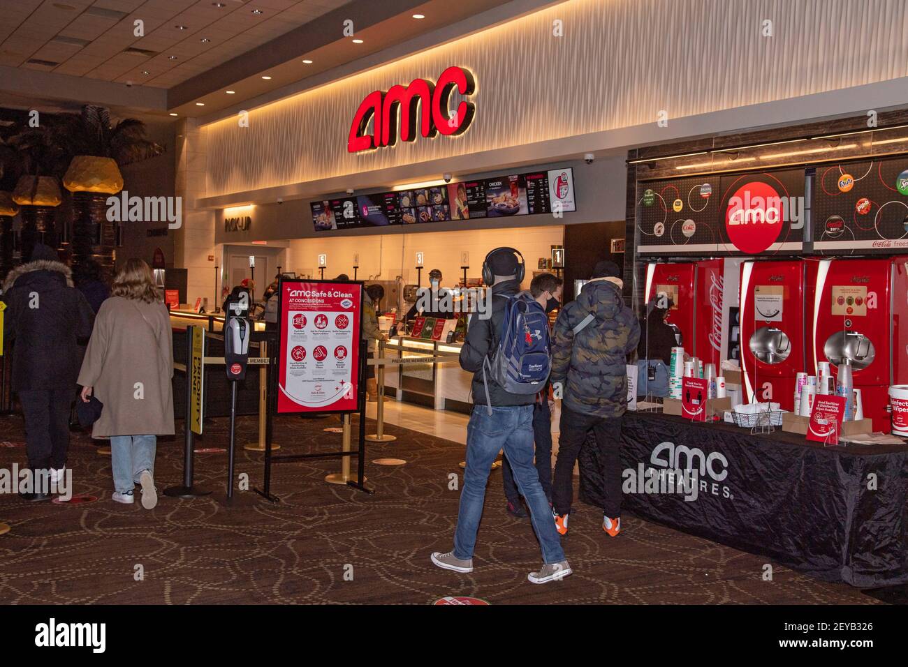 NEW YORK, NY - MARCH 05: Social distancing stickers and signs are seen by the concession stand at the AMC Loews Lincoln Square 13 movie theater on March 05, 2021 in New York City. AMC Theatres reopened its New York area locations today, with new safety precautions in place, for the first time since closing in March because of the coronavirus (COVID-19) pandemic. Stock Photo