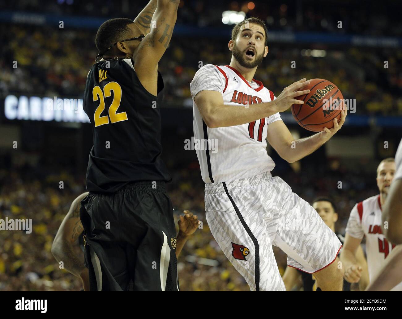 Luke Hancock (11) of Cardinals drives against Carl Hall (22) of Wichita ...