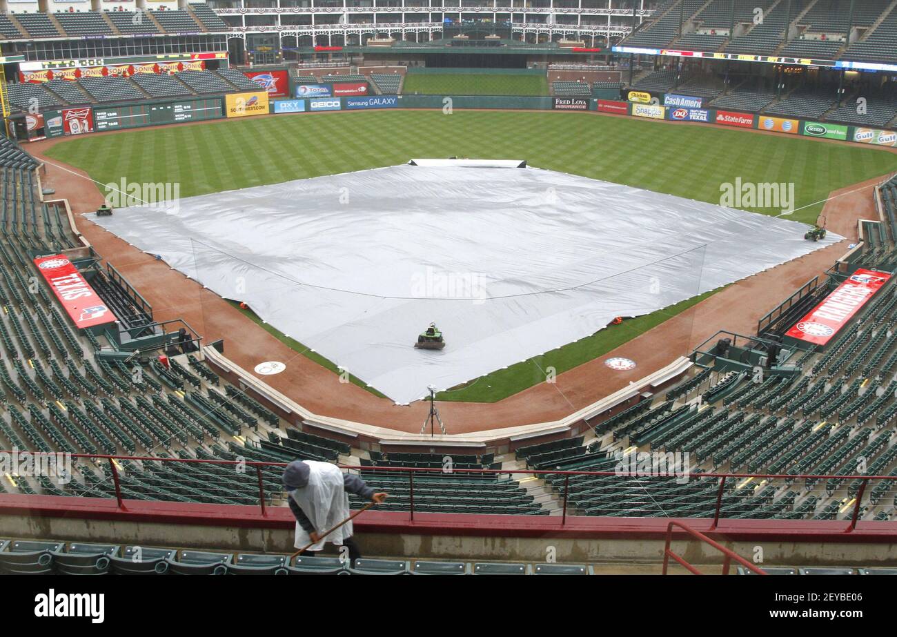A tarp covers the field as rain falls before the Tampa Bay Rays visit