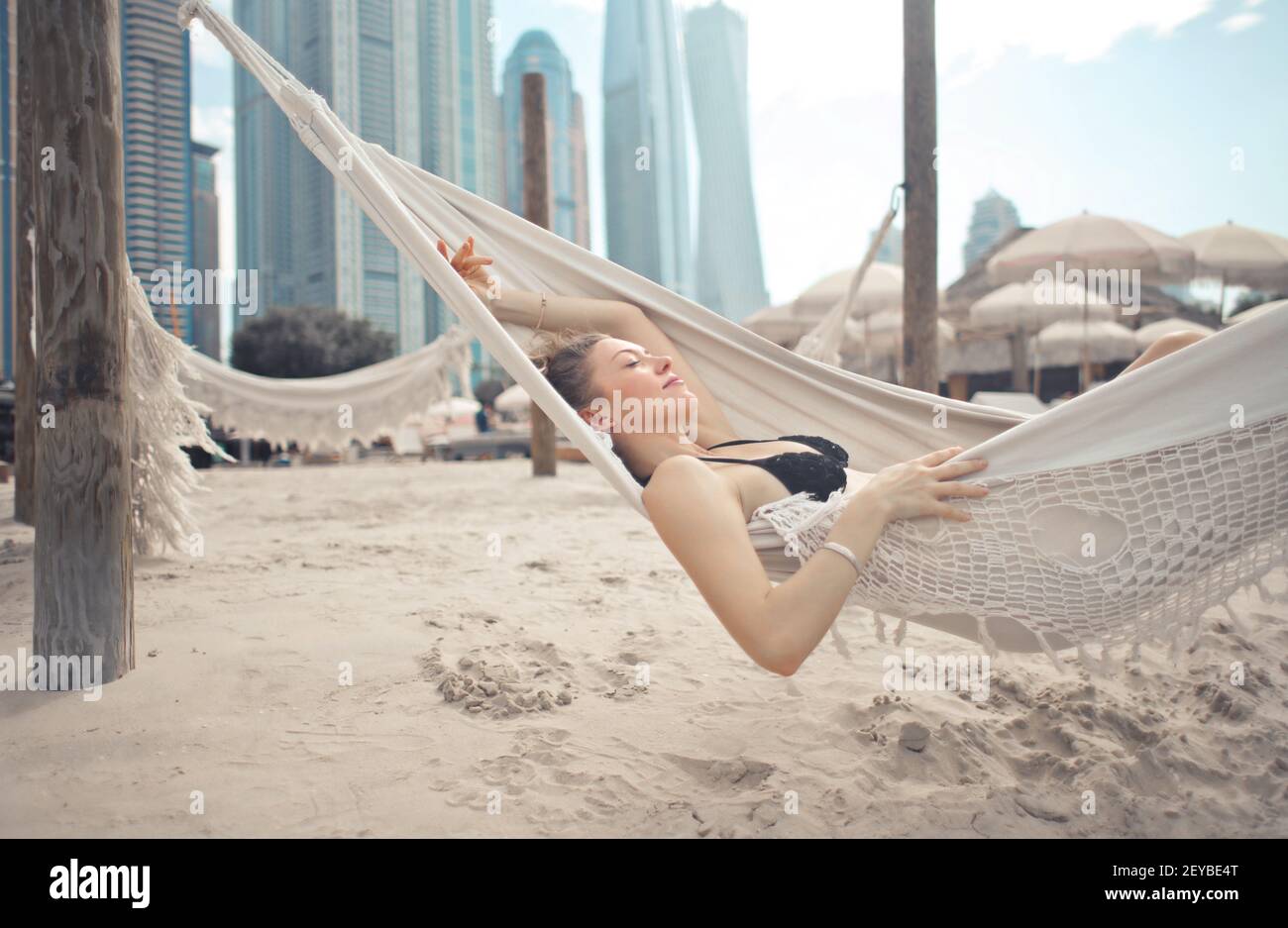 A young European female relaxing on a hammock Stock Photo