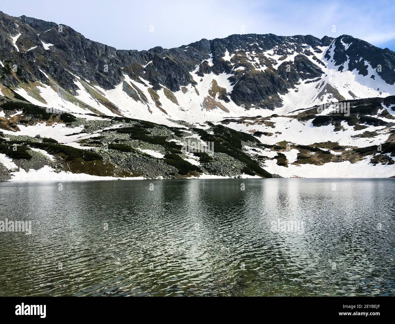 Stunning mountainscape reflecting in the water, winter nature of the Five Polish Ponds Valley Stock Photo