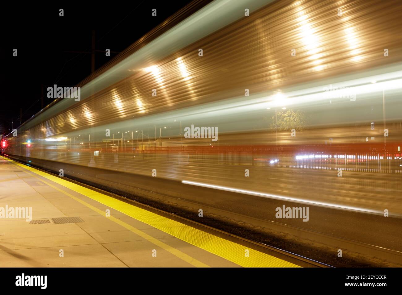 Train Leaving Terminus at Night Stock Photo
