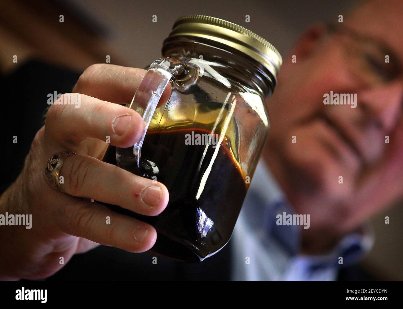 Williston, North Dakota Mayor E. Ward Koeser displays a jar containing  Bakken crude oil, May 2, 2013. (Photo by Jim Gehrz/Minneapolis Star  Tribune/MCT/Sipa USA Stock Photo