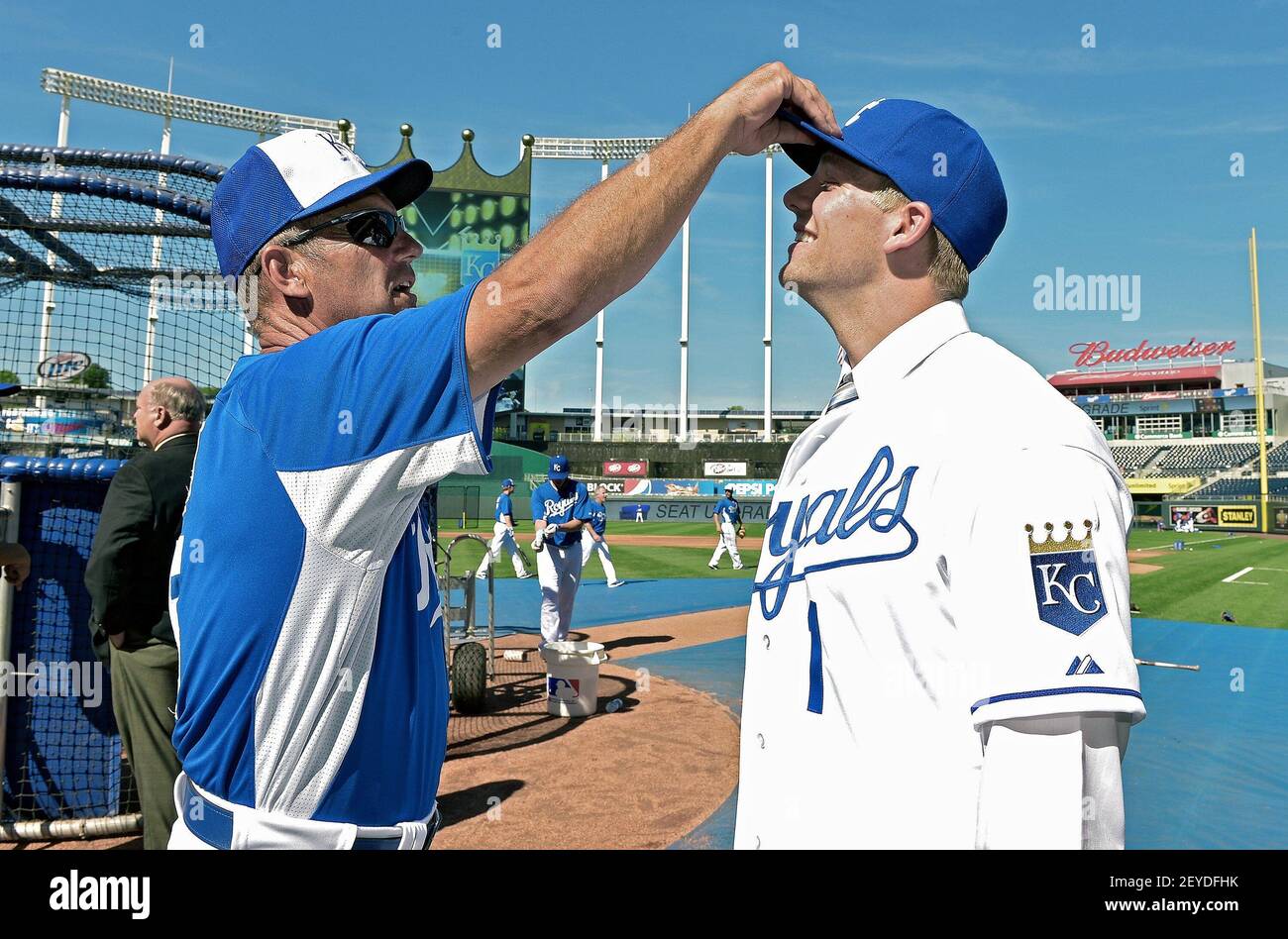 Kansas City Royals hitting coach George Brett (5) checked to see how tall  the teams first round draft pick Hunter Dozier was, after he signed and  watched batting practice before Monday's baseball