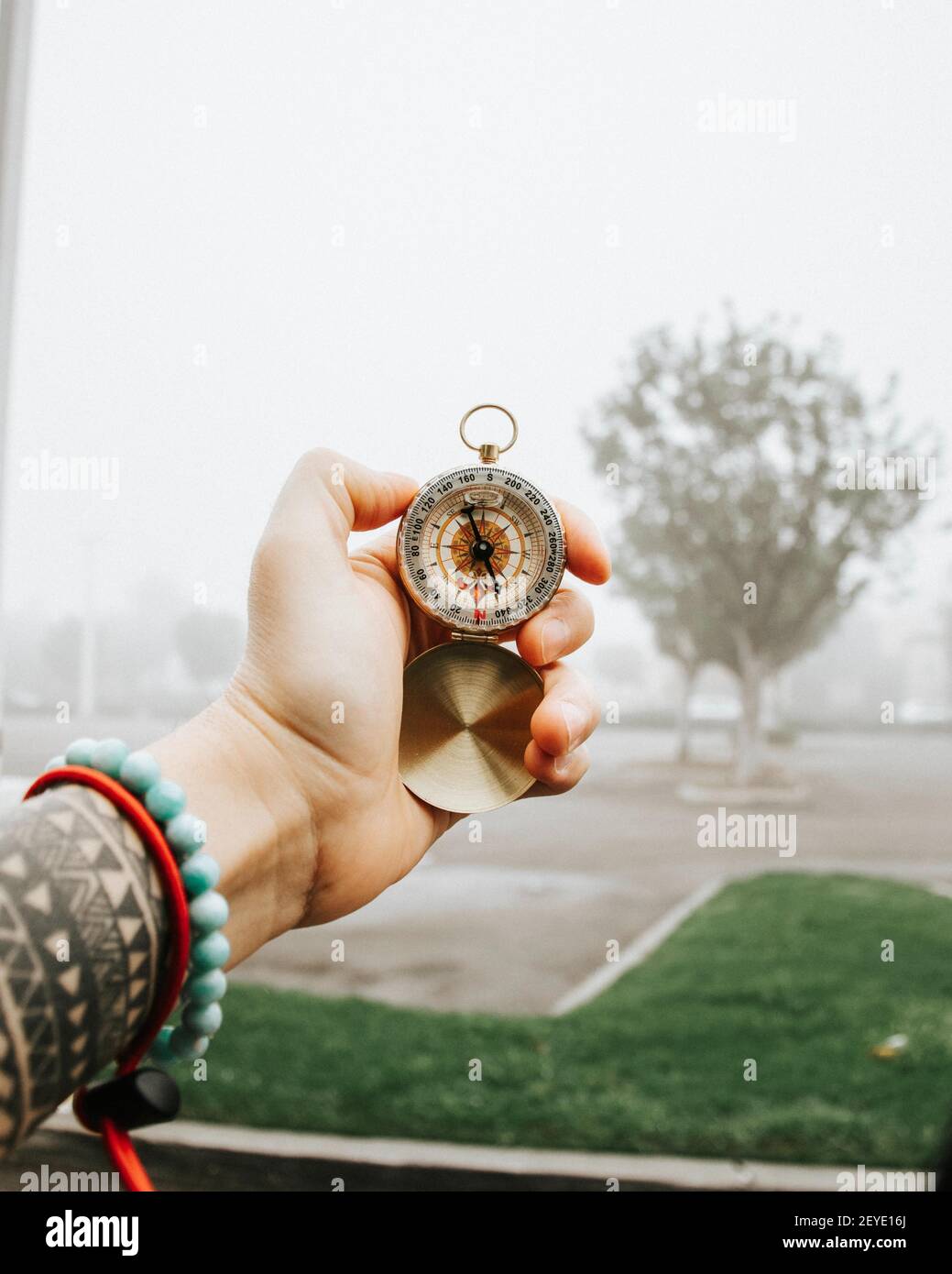 LAGUNA BEACH, UNITED STATES - Sep 10, 2019: Holding a compass in the ...