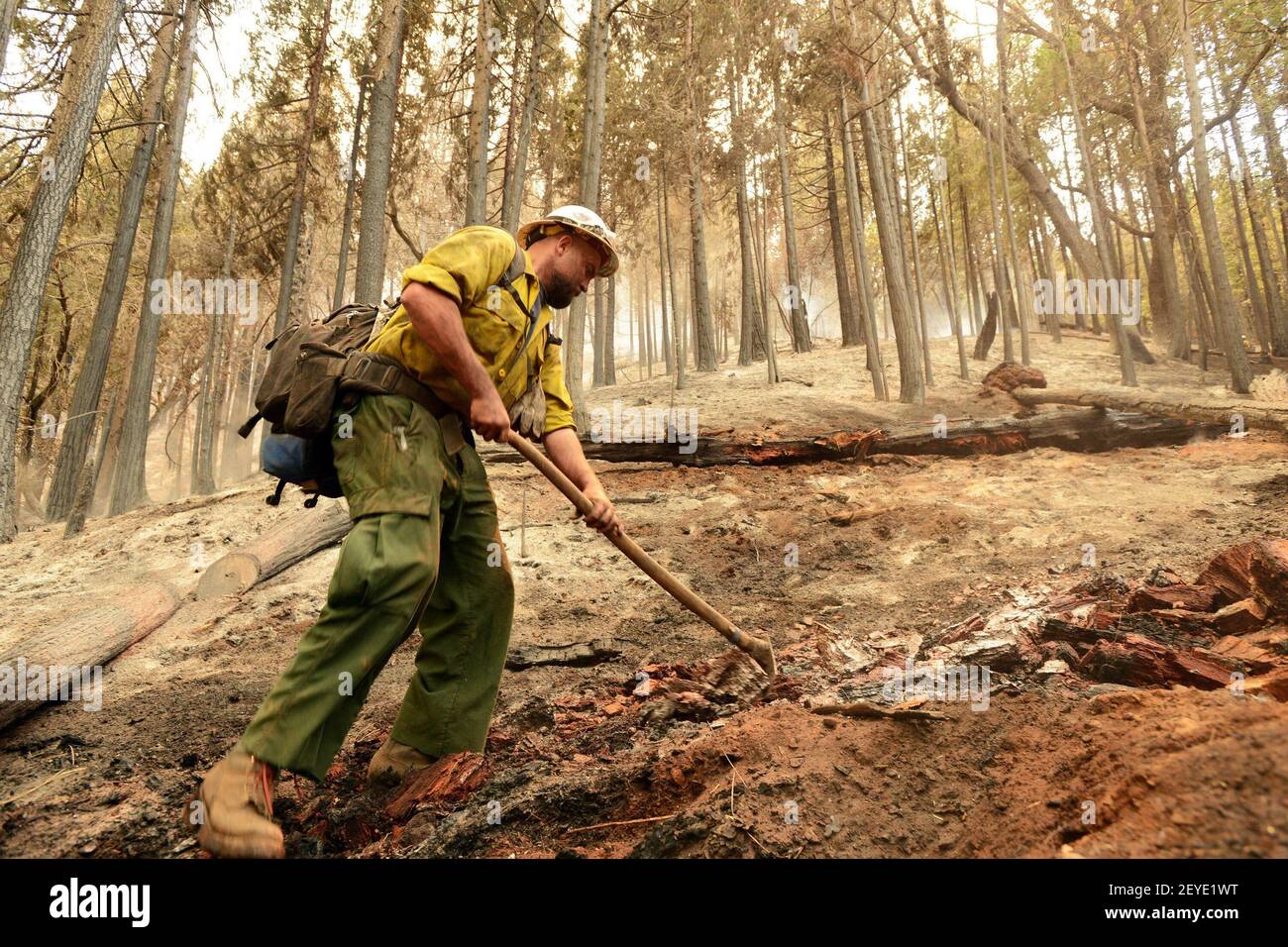 U.S. Forest Service fireman Bo Rice, 28, works on putting out hot spots ...