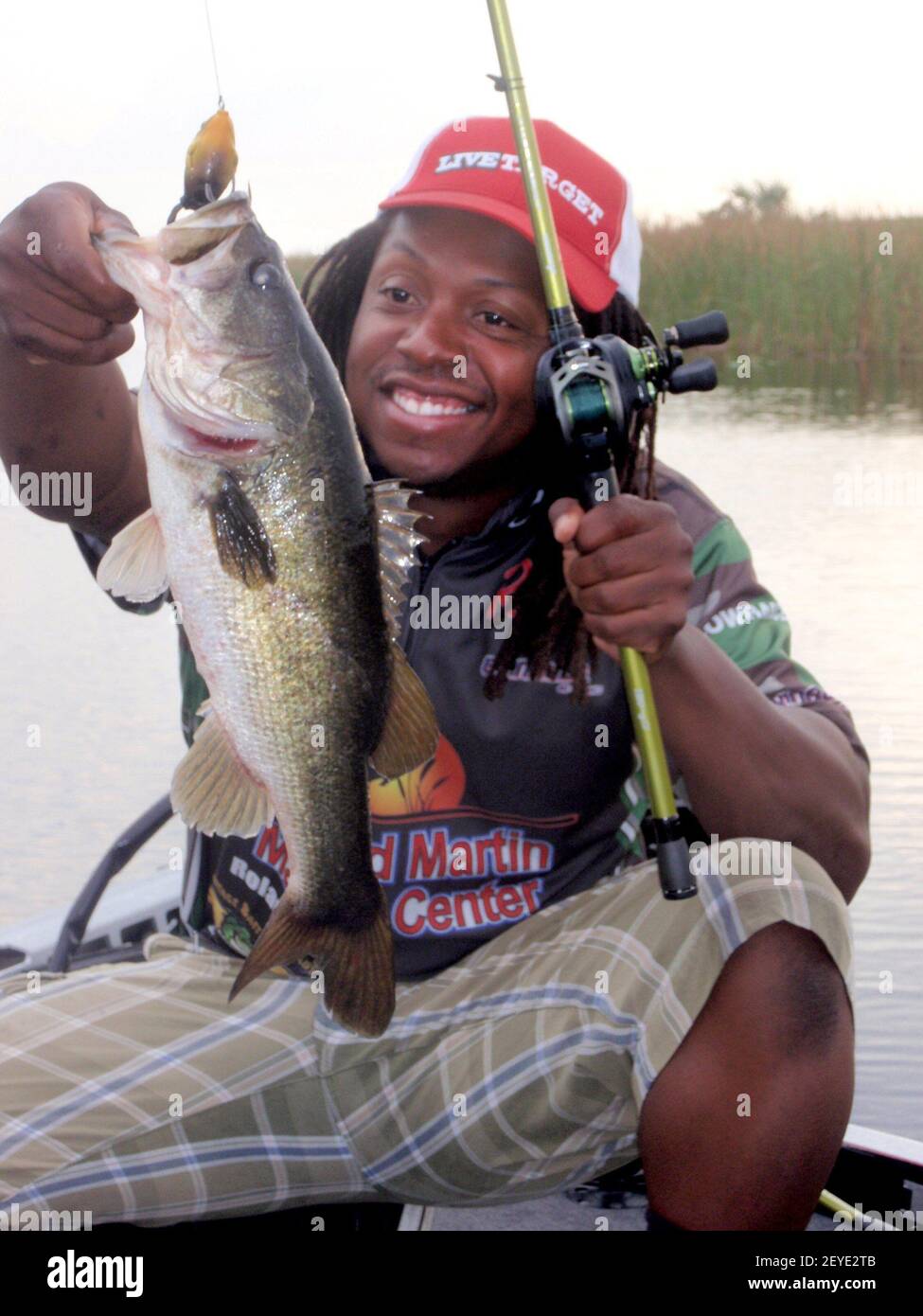 Tamarac, Florida, bass guide Anthony Hunt holds up a largemouth he caught  using a plastic frog in an Everglades canal. As part of his guide service,  he also caters lunch. (Photo by