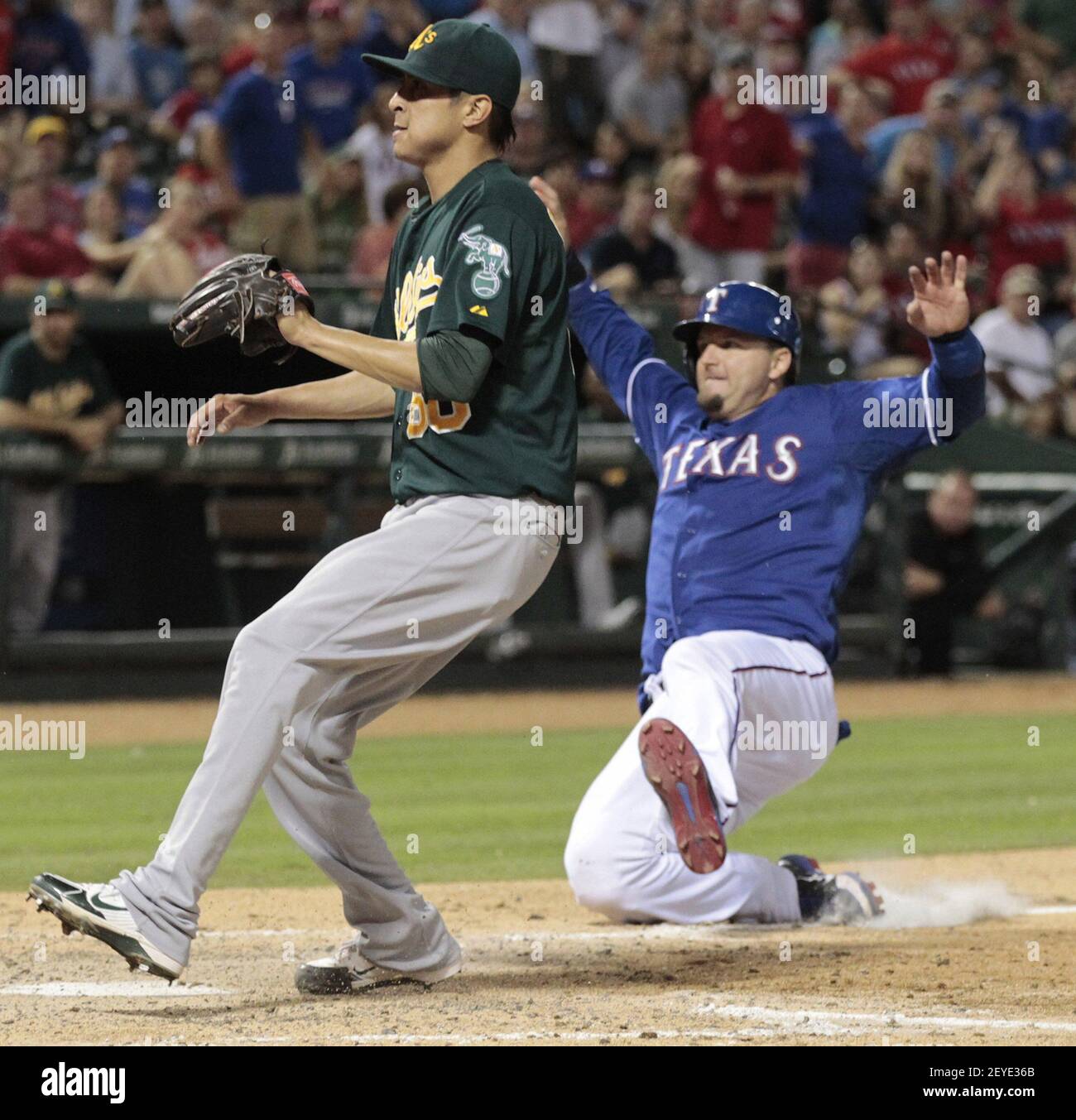 The Texas Rangers A J Pierzynski Right Scores On A Wild Pitch Behind Oakland Athletics Relief Pitcher Jesse Chavez In The Seventh Inning At The Rangers Ballpark In Arlington On Wednesday June 19