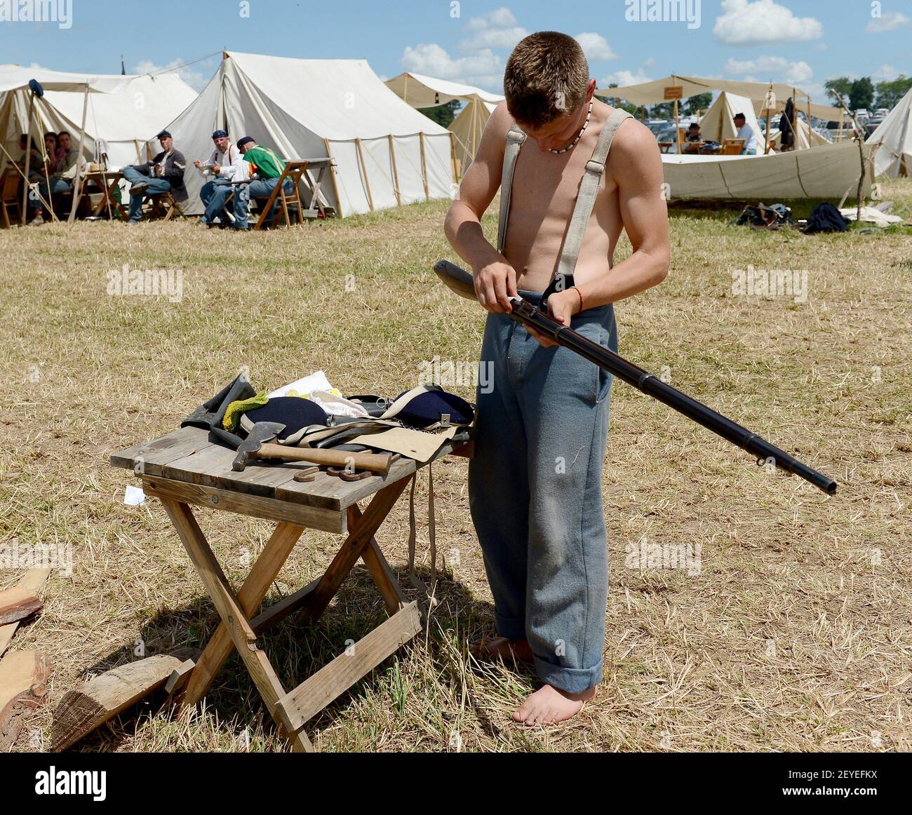 Union re-enactor Connor Barnes, of Sodus, New York, cleans his rifle in ...