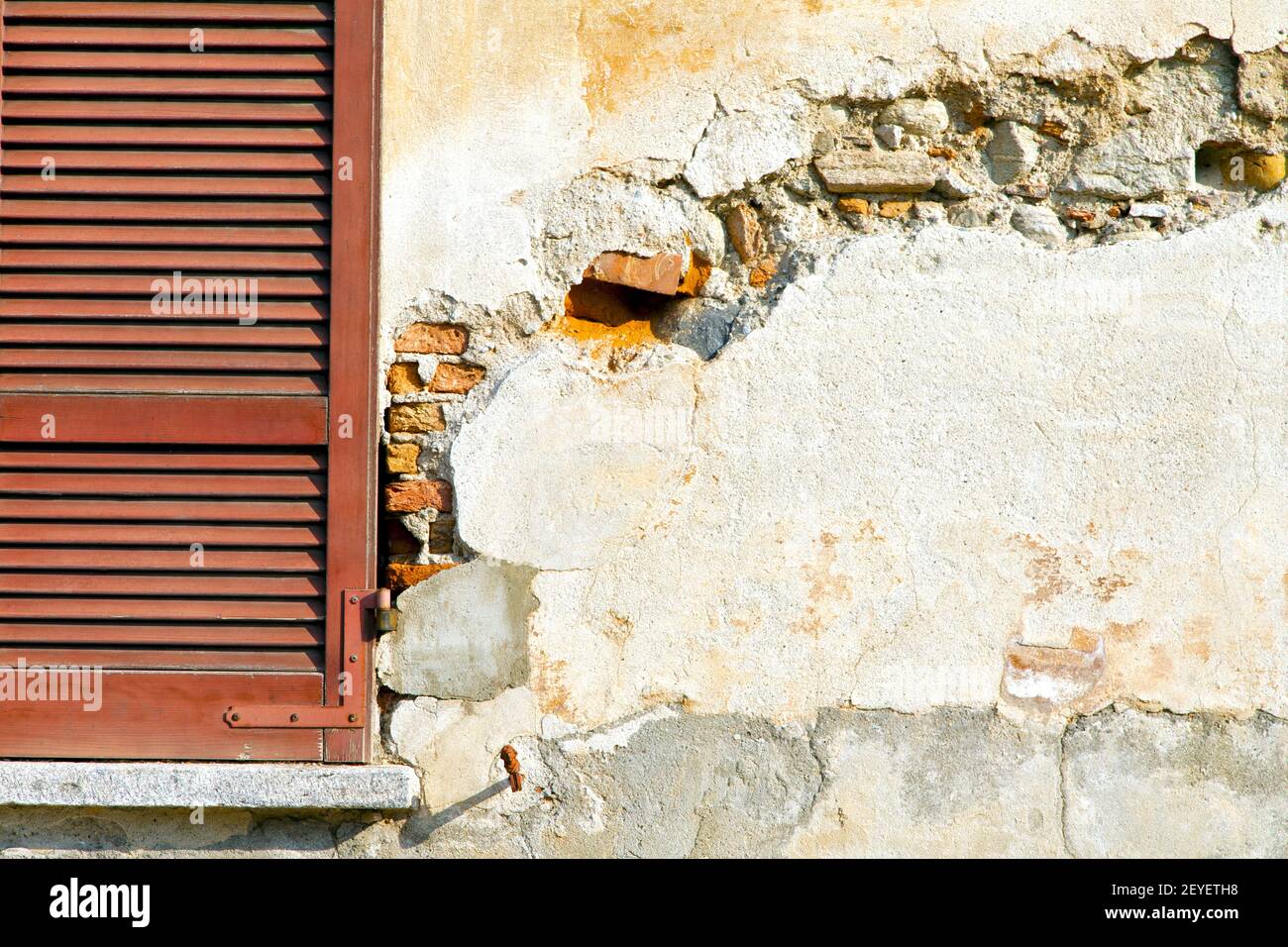 Window  varano borghi palaces      venetian blind in the concrete  brick Stock Photo