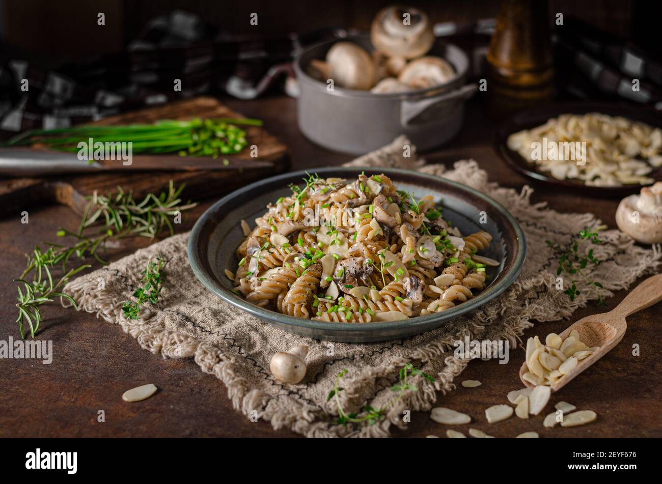 Original creamy pasta with mushrooms, herbs and almond slices Stock Photo