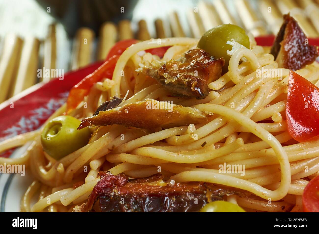 Salsa spaghetti with sardines Add the chilli flakes, tomatoes Stock Photo Alamy