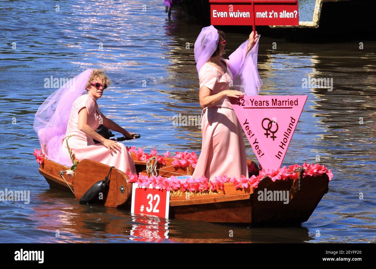People attend the Canal Parade at Prinsengracht in Amsterdam