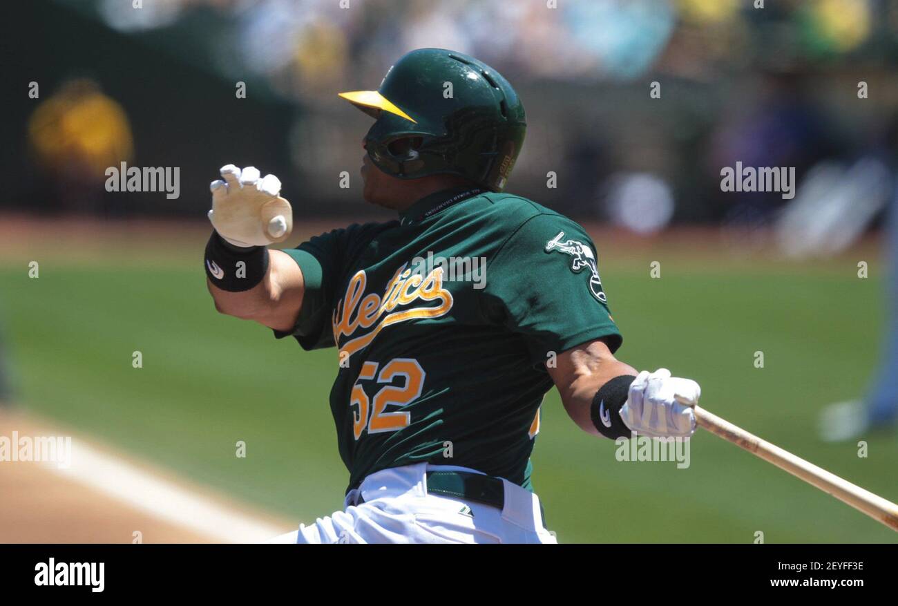 Oakland Athletics' Yoenis Cespedes, right, celebrates his solo home run  with teammate Josh Reddick (16) during the fourth inning of the second game  of a doubleheader baseball game against the Seattle Mariners