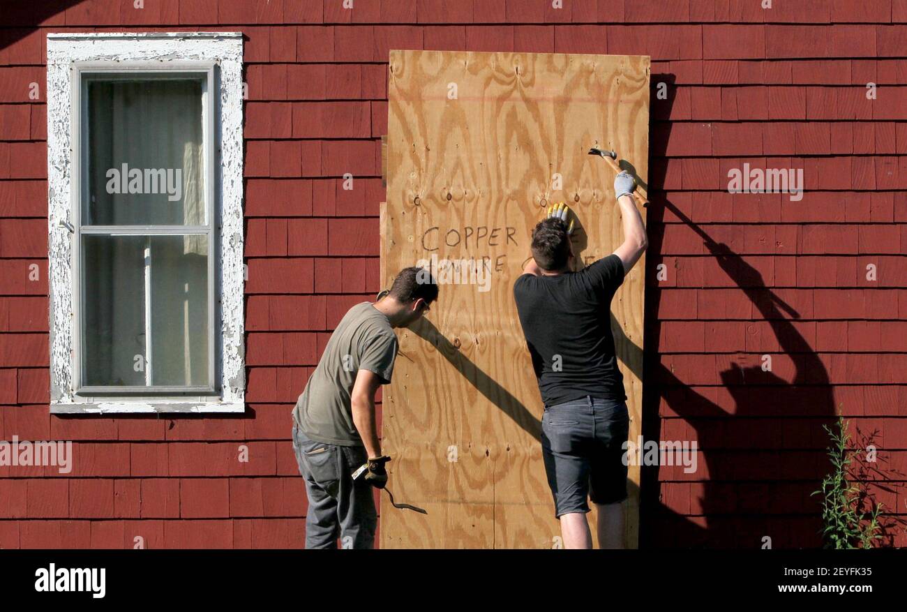 Jason Horinger, right, and Micah Kraus look through a house scheduled to be  torn down in Akron, Ohio, searching for items they can salvage and resell.  (Photo by Ed Suba Jr./Akron Beacon